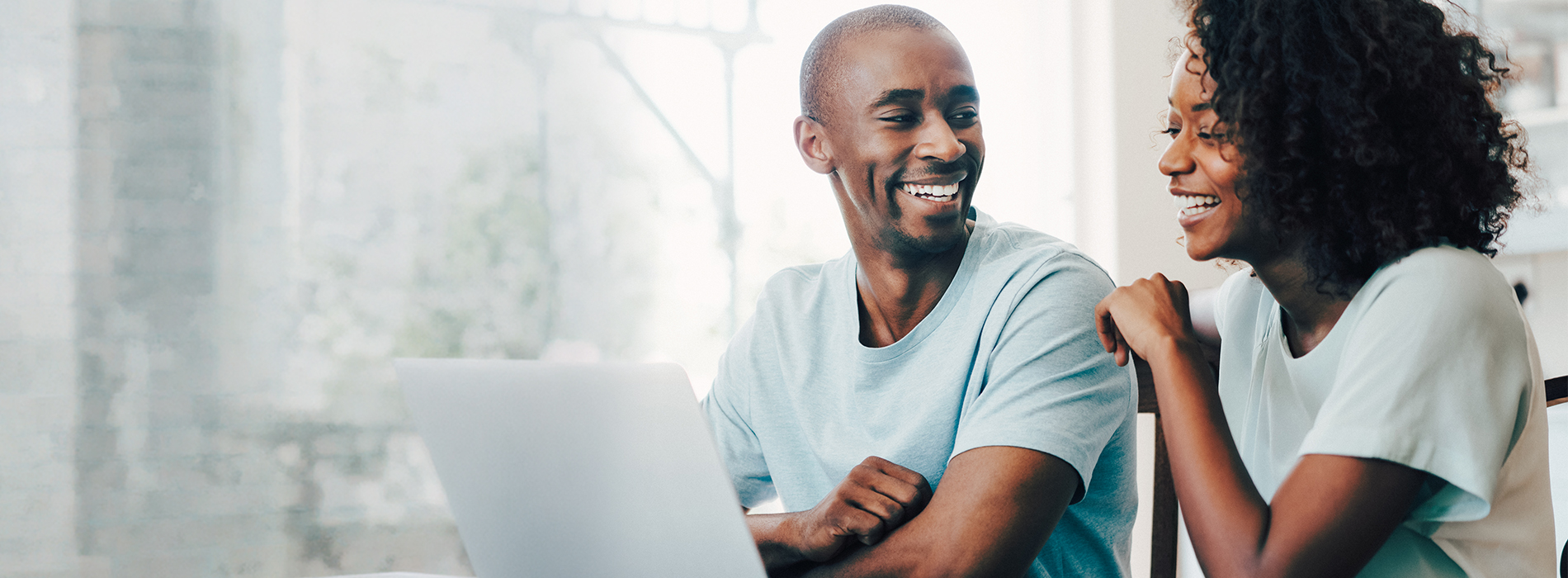 Couple sitting in front of laptop