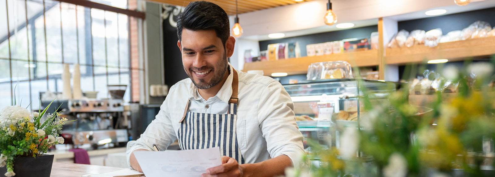business owner smiling at paper work