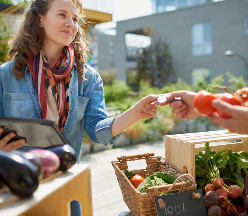 Woman working with fresh produce at her business